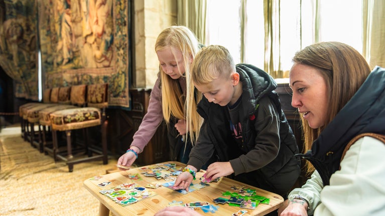 Families playing puzzles in the house at Hardwick Hall, Derbyshire
